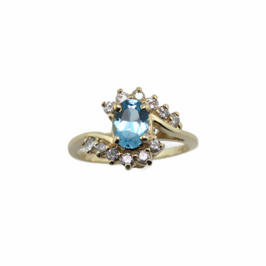 Oval Blue Topaz and diamond ring in Yellow gold