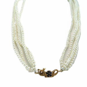 4 strands of seed pearls with a decorative hidden clasp with Sapphires